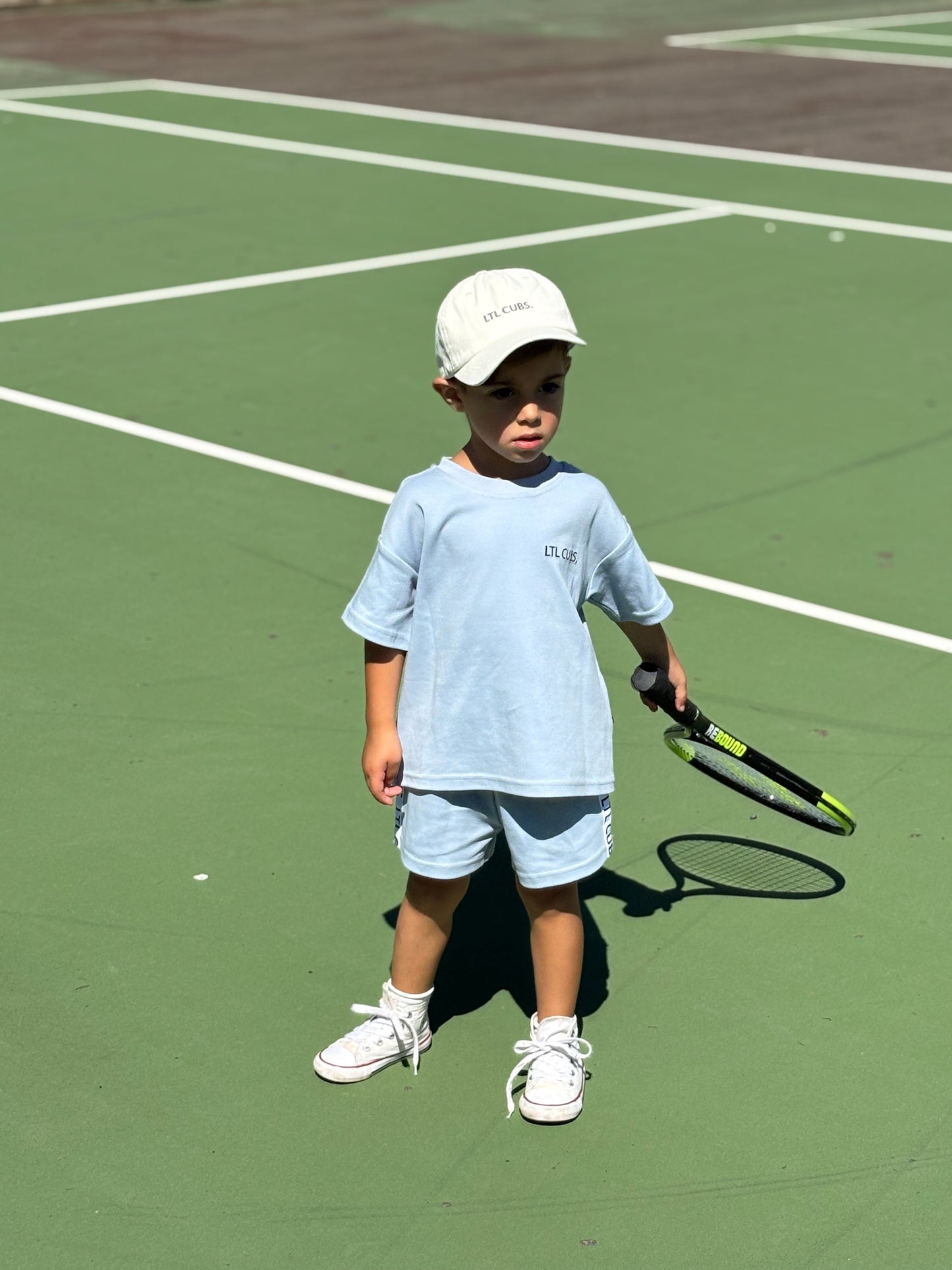Kid wearing blue sporty cubs shirt and short set. oversized box shape tee. sport clothes