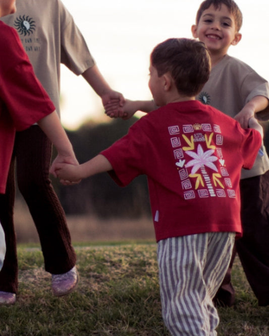 Let your little one stand out in our bold red Sunset Palms Tee. Vibrant, playful, and comfy perfect for spotting your mini in a crowd. Unisex, soft cotton, made to last.