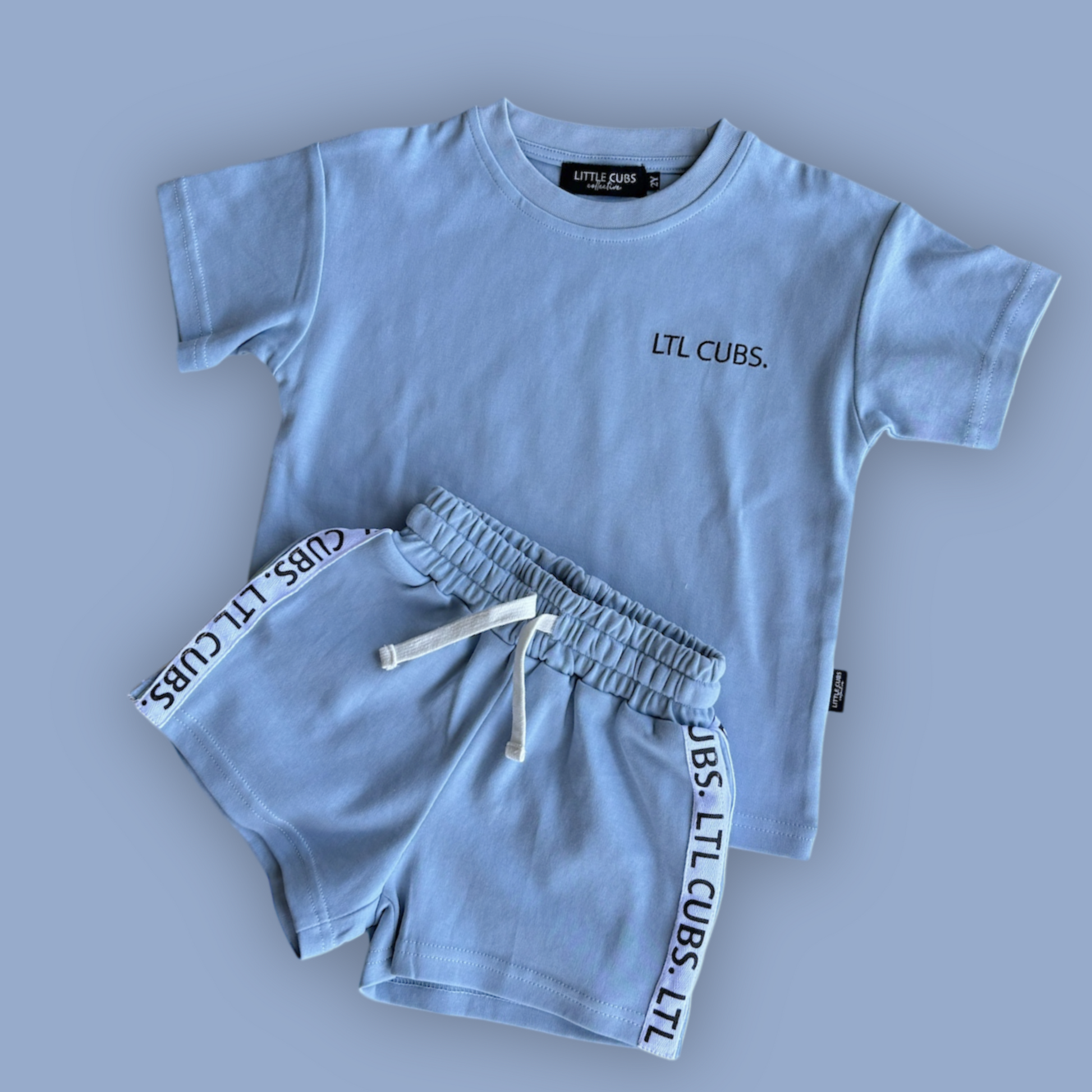 Sporty Cubs kids dusty blue set with sporty strip down the side of the shorts. Shorts have a draw string and embroided label on the shirt. Over sized
